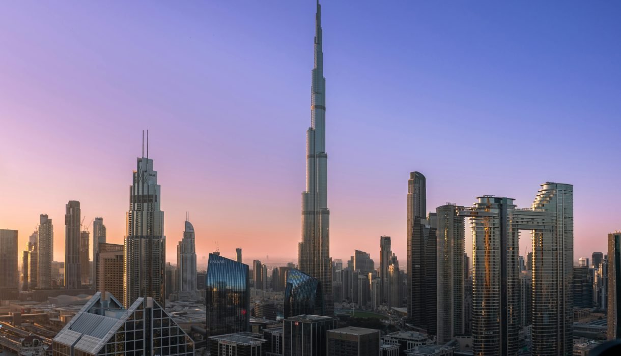 The iconic Burj Khalifa rises majestically over Dubai's modern skyline at sunrise.