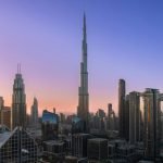 The iconic Burj Khalifa rises majestically over Dubai's modern skyline at sunrise.